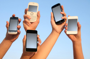 Holding mobile phones - Shutterstock